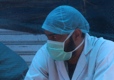 Close-up portrait of man wearing mask