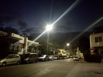 Cars on street amidst buildings in city