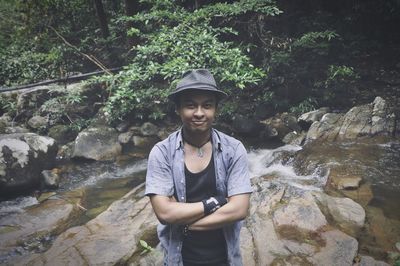 Young man standing by river