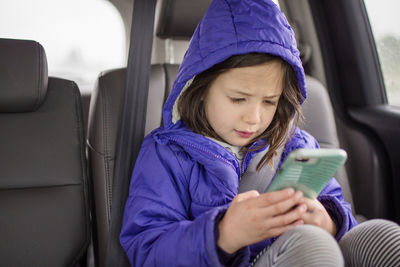 Close-up of girl sitting in bus