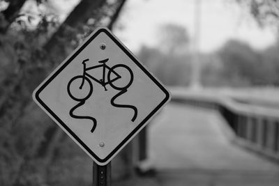 Close-up of bicycle sign against blurred background