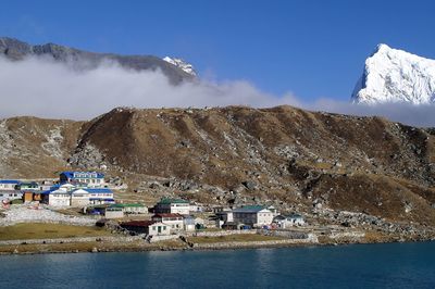 Houses on mountain by lake