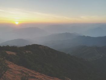 Scenic view of mountains against sky during sunset