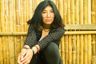 Portrait of a beautiful young woman sitting outdoors