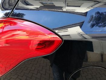 Reflection of red car in mirror