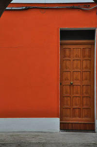 Closed door on orange wall