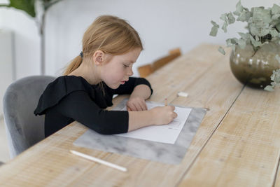 Girl doing homework at table