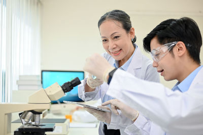 Female doctor examining patient in laboratory