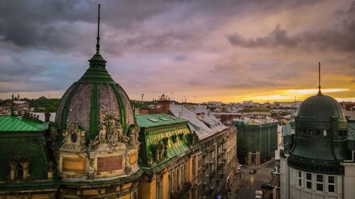 Panoramic view of buildings in city against sky during sunset