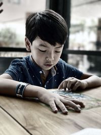 Portrait of boy looking at table