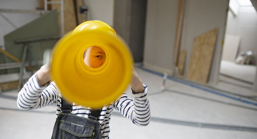 Close-up of yellow hardhat on table