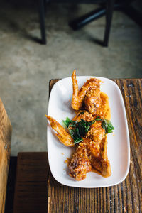 Deep fried thai chicken wings with garlic, chili paste, and fish sauce