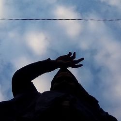 Low angle view of silhouette statue against sky