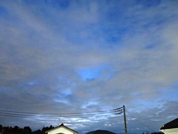 Low angle view of electricity pylon against sky