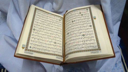 High angle view of koran on textile