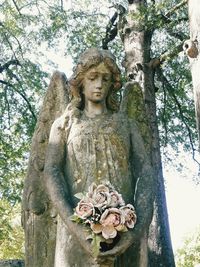 Buddha statue on tree trunk