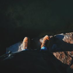 Low section of person standing on rock