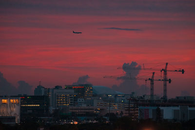 Silhouette buildings against sky during sunset