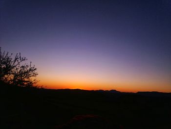 Scenic view of silhouette landscape against clear sky during sunset