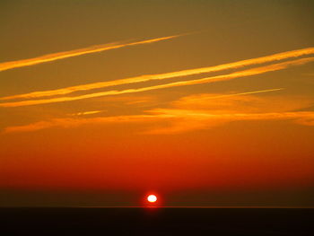 Scenic view of sea against romantic sky at sunset