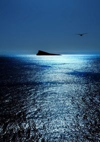 Scenic view of sea against clear blue sky