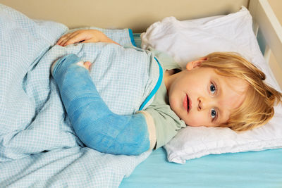 Portrait of cute baby boy sleeping on bed at home