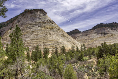 Panoramic view of land and mountains against sky