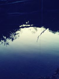 Close-up of reflection in sea against sky