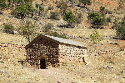 Built structure on field against trees