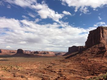 View of desert against cloudy sky