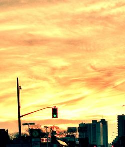 Low angle view of buildings against sky at sunset