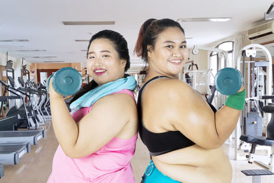 Female friends exercising in gym