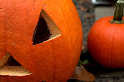 Close-up of pumpkin on orange stone wall during halloween