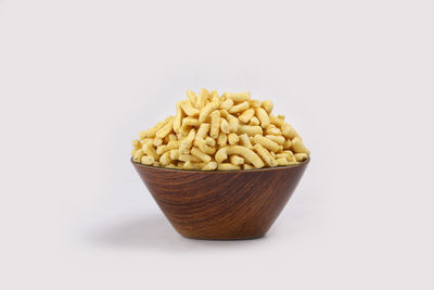 Close-up of bread in bowl against white background