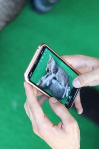 Midsection of man holding smart phone