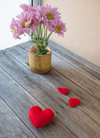 Close-up of red flower vase on table