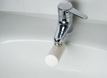 Close-up of faucet in bathroom