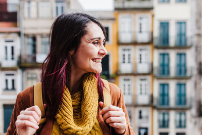 Beautiful young woman smiling in city