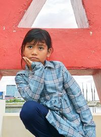 Portrait of boy sitting outdoors