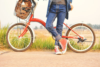 Man standing by bicycle