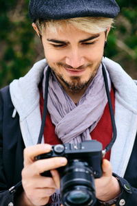 Close-up of man holding camera