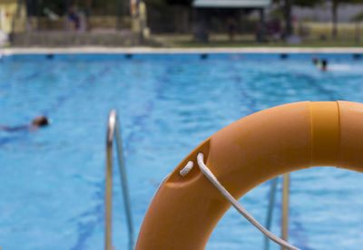 Close-up of life belt against swimming pool