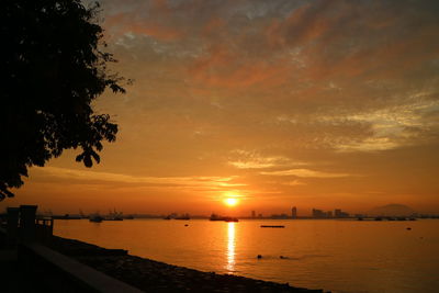 Scenic view of sea against orange sky