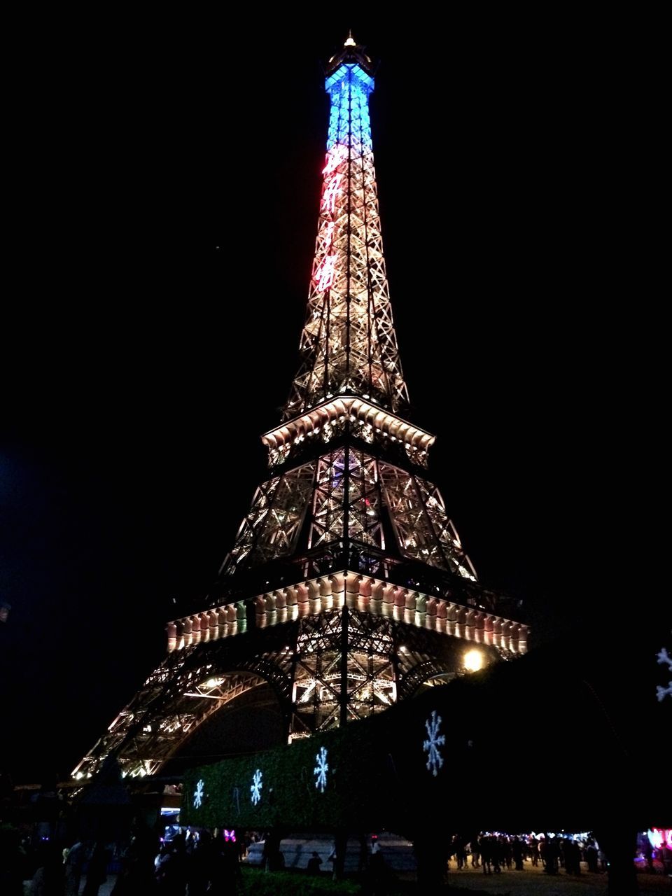 illuminated, night, famous place, architecture, travel destinations, international landmark, built structure, tourism, travel, capital cities, building exterior, low angle view, city, tall - high, tower, eiffel tower, sky, architectural feature, clear sky, spire