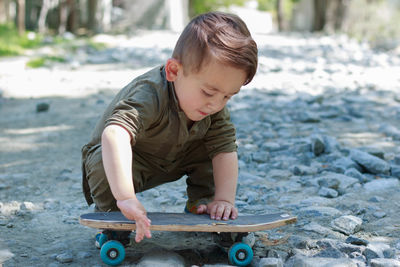 Cute boy playing with skateboard