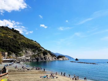 People on beach against sky