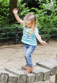 Full length of girl standing on footbridge