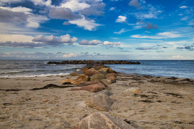 Rocks on beach against sky