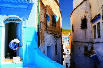 Low angle view of houses against clear blue sky