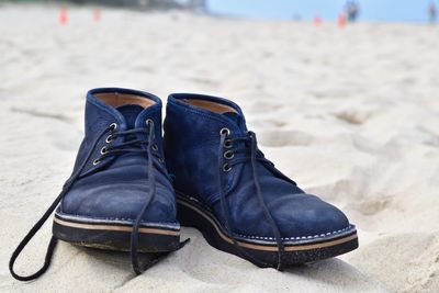 Close-up of shoes on sand